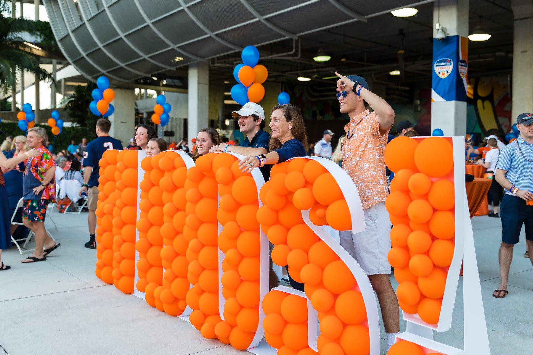 Hoos standing behind a balloon structure that spells "HOOS"