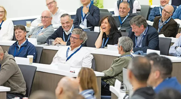 Darden students sitting in a classroom, laughing