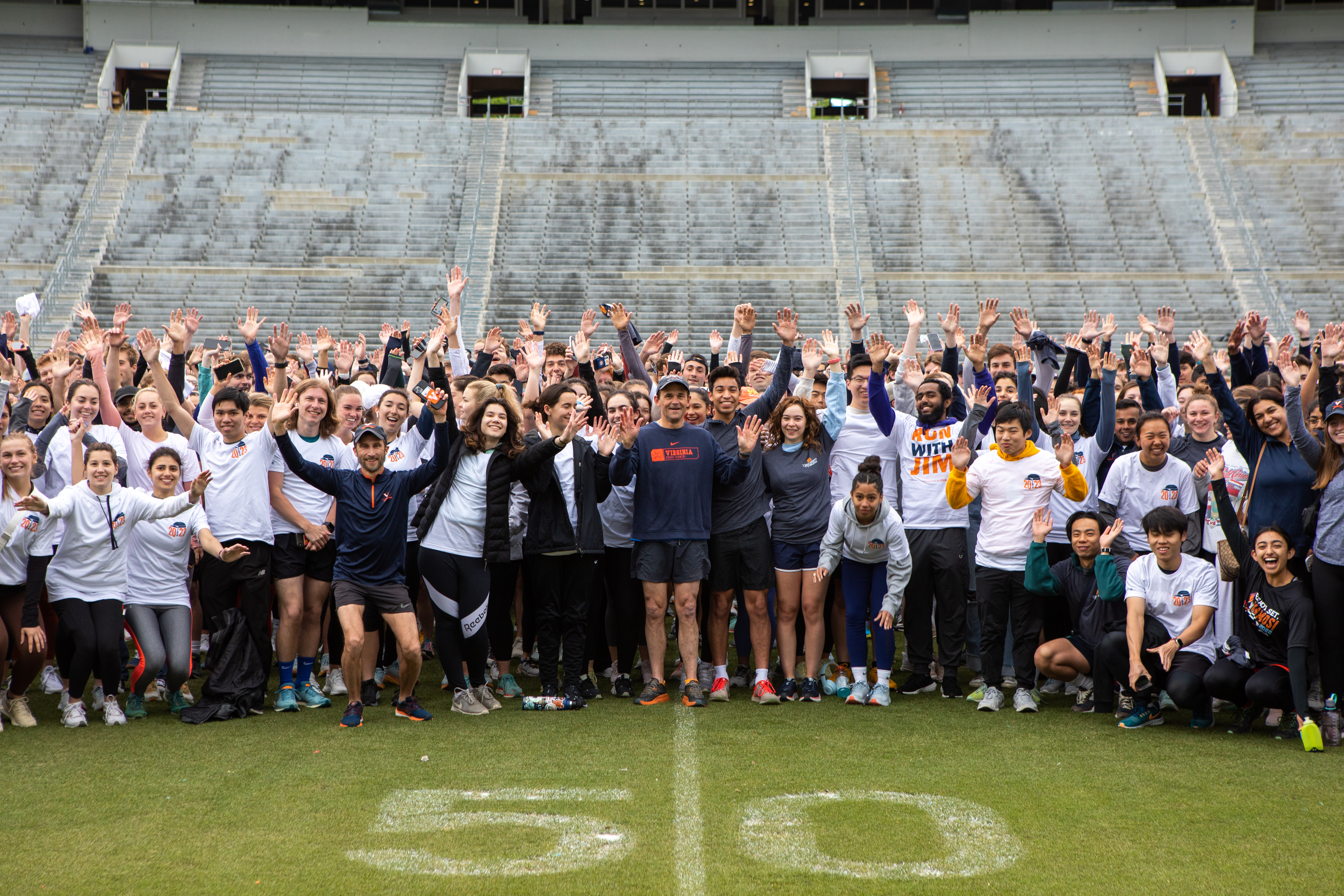Students on the field of Scott Stadium with UVA President Jim Ryan at the start of the 2023 4th Year Run with Jim