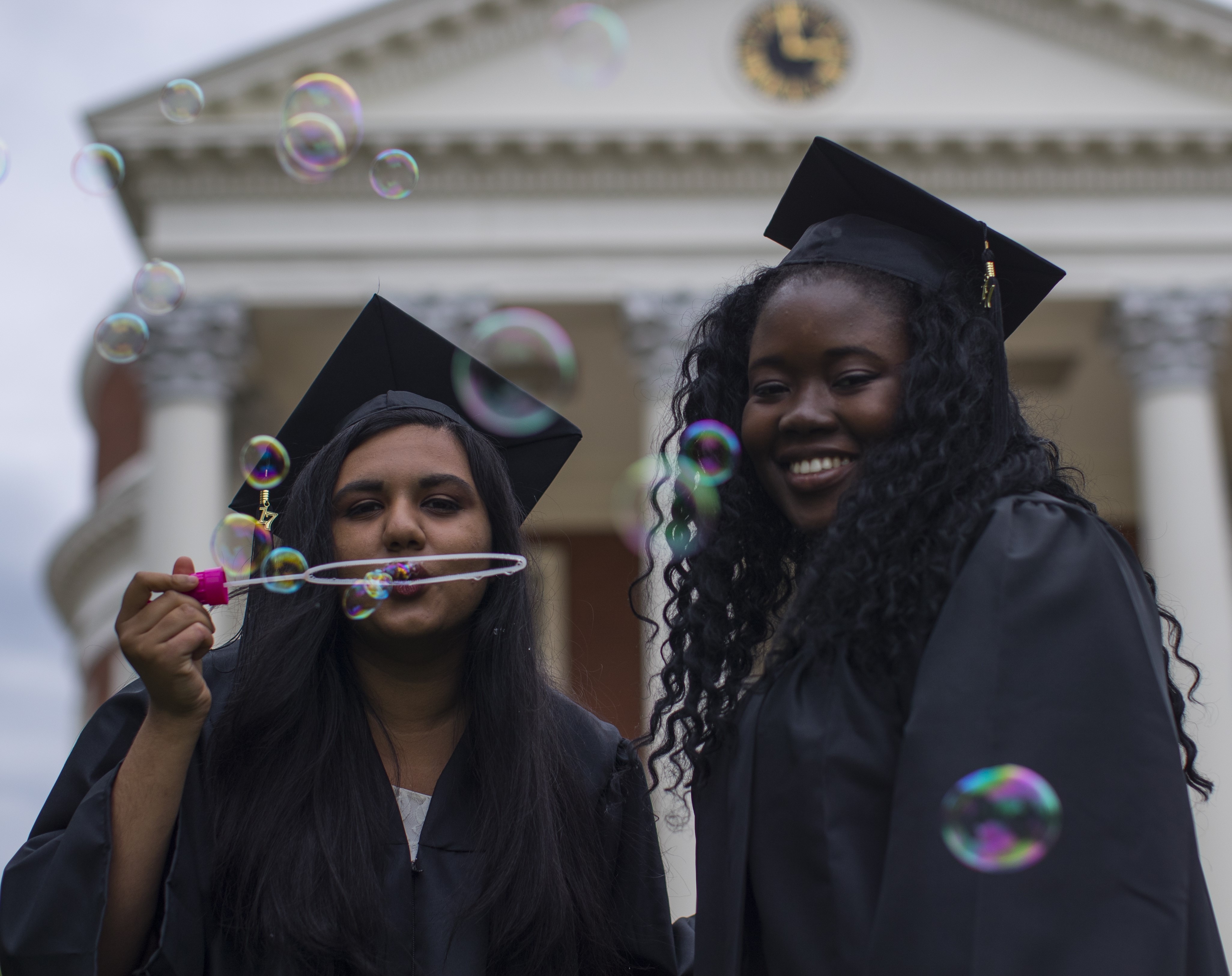 Students blowing bubbles at Final Exercises standing in front of the Rotunda