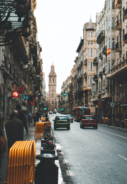 Image of a pedestrian and car traffic along an avenue in Valencia Spain