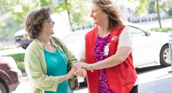 Escort volunteer helping a patient inside the hospital