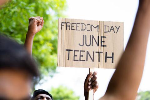 Freedom Day Juneteenth sign and hands raised