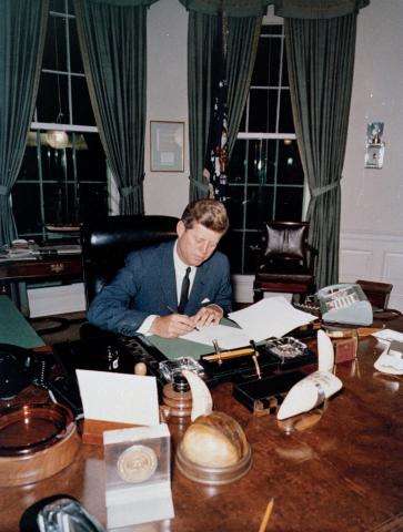 President John F. Kennedy signs the Interdiction of the Delivery of Offensive Weapons to Cuba