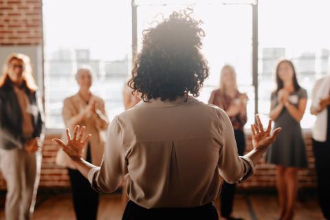 Woman empowering other colleagues in workplace