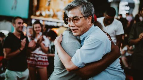 Two people hugging in Times Square